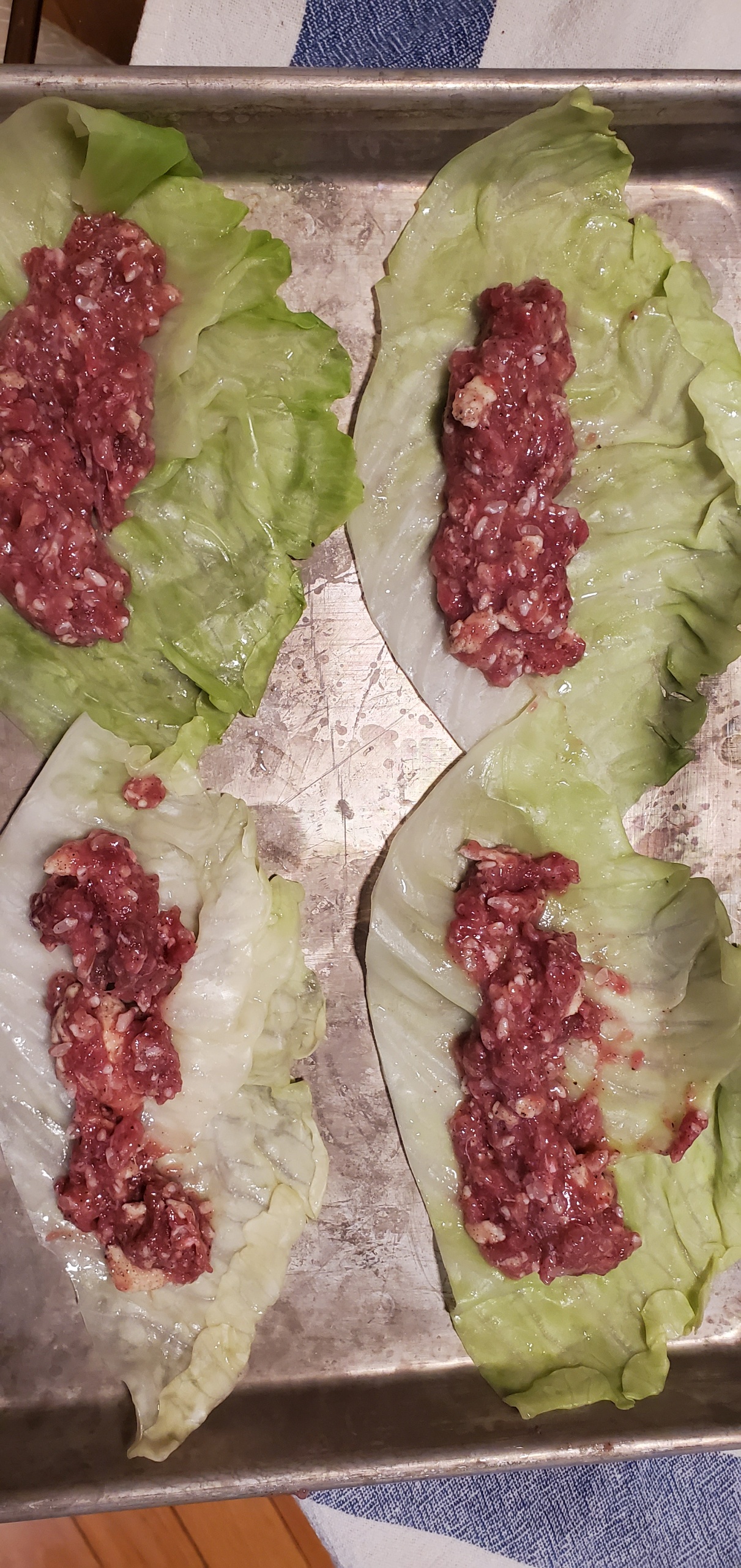 Filling placed on cabbage leaves before rolling